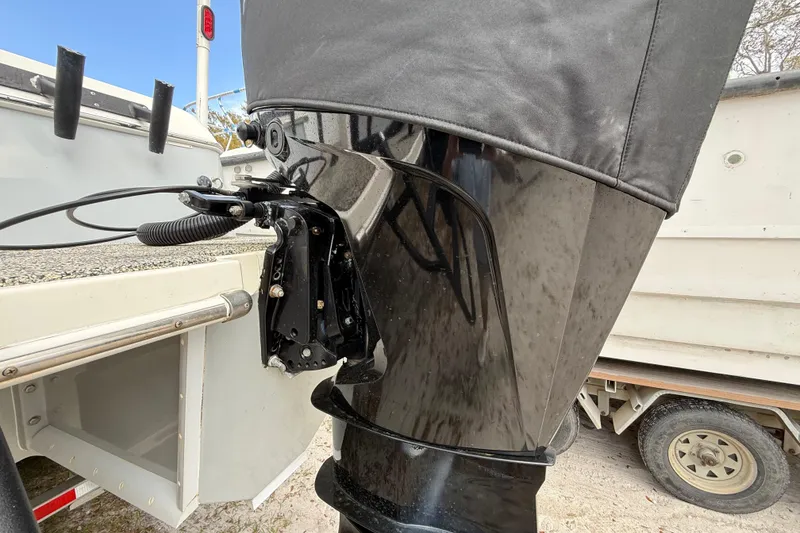 Slide: The Image of 2022 Eastward 30 boat engine with protective cover, parked on a trailer. - 122