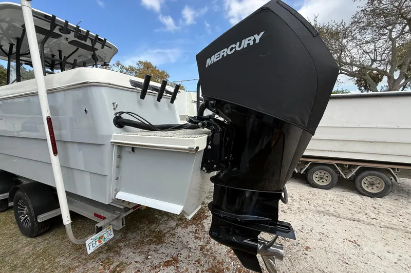Slide: The Image of 2022 Eastward 30 boat with Mercury outboard motor, parked on a trailer. - 128