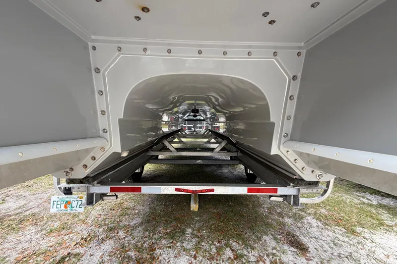 Slide: The Image of Underneath view of a 2022 Eastward 30 boat on a trailer, showcasing hull design. - 129