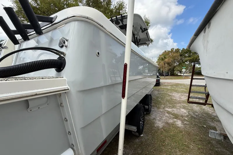 Slide: The Image of 2022 Eastward 30 boat on trailer, side view with clear sky background. - 131