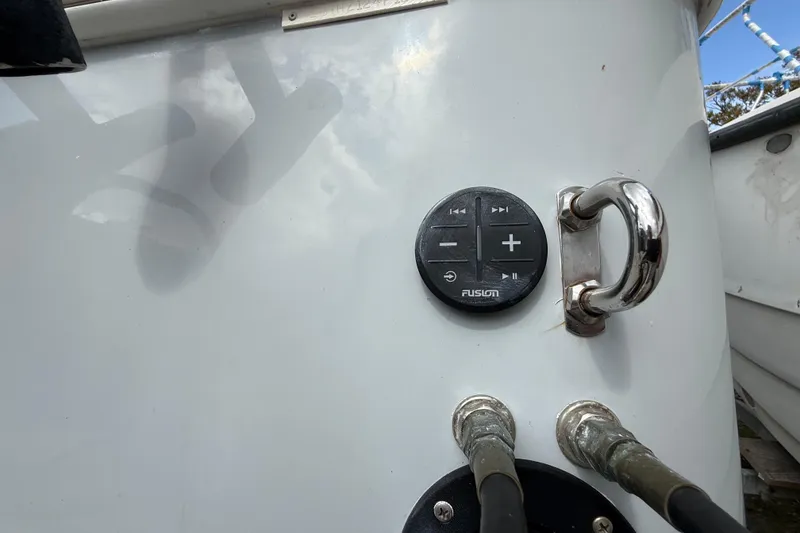 Slide: The Image of Control panel on Eastward 30 boat, featuring Fusion audio controls and metal handle, 2022 model. - 132
