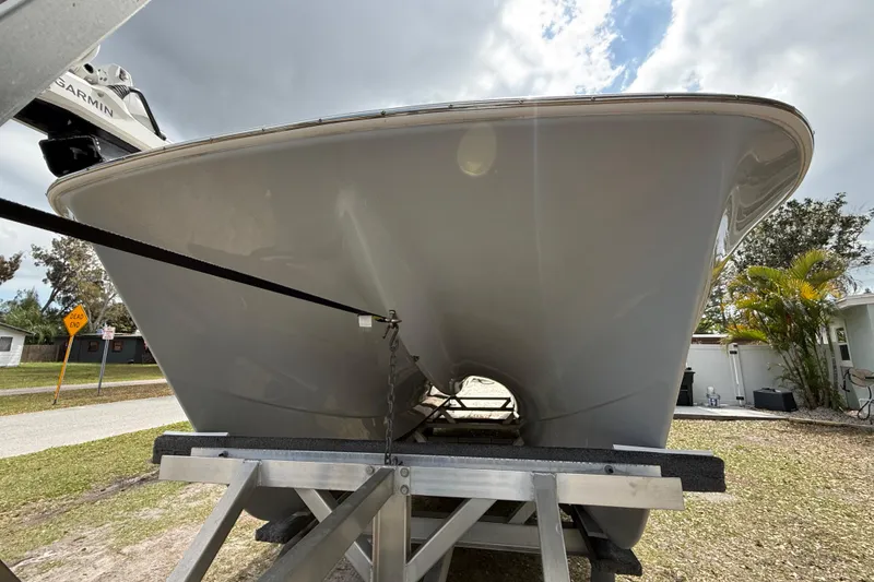 Slide: The Image of 2022 Eastward 30 boat on trailer, viewed from the front under a cloudy sky. - 14