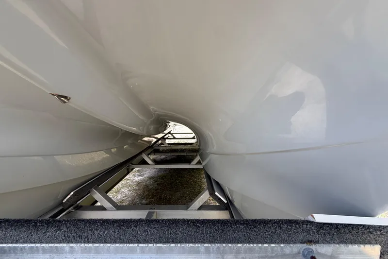 Slide: The Image of Underneath view of a 2022 Eastward 30 boat hull on a trailer. - 15
