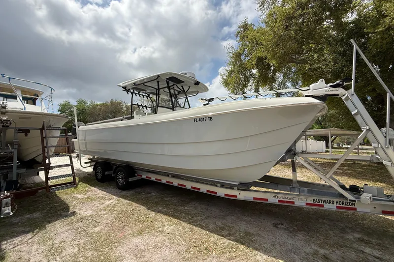 Slide: The Image of 2022 Eastward 30 boat on trailer under cloudy sky, parked outdoors. - 20