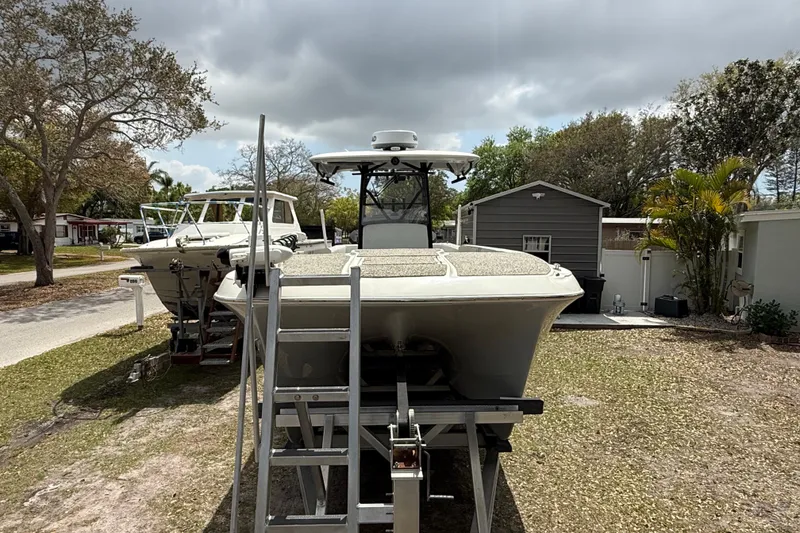 Slide: The Image of 2022 Eastward 30 boat on trailer, parked outdoors under cloudy sky. - 26