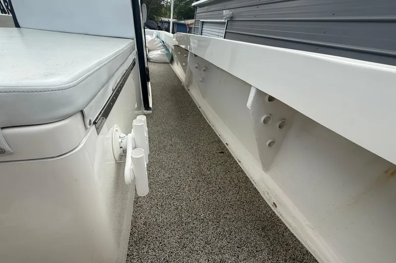 Slide: The Image of 2022 Eastward 30 boat interior with rod holders and cushioned seating. - 36