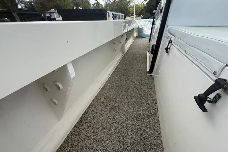 Slide: The Image of Side view of 2022 Eastward 30 boat with white railing and textured flooring. - 37