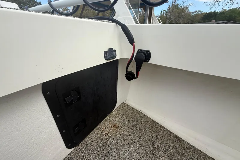 Slide: The Image of Interior view of a 2022 Eastward 30 boat showing wiring and storage compartment. - 38