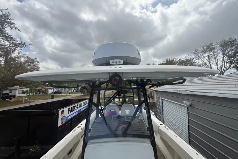 Slide: The Image of 2022 Eastward 30 boat with radar, parked outdoors under cloudy sky. - 44