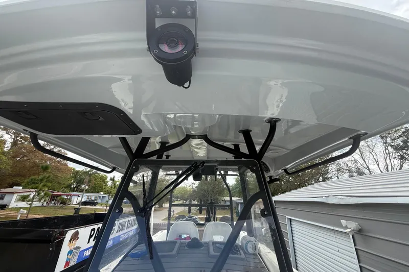 Slide: The Image of 2022 Eastward 30 boat with T-top and mounted camera, parked outdoors. - 47