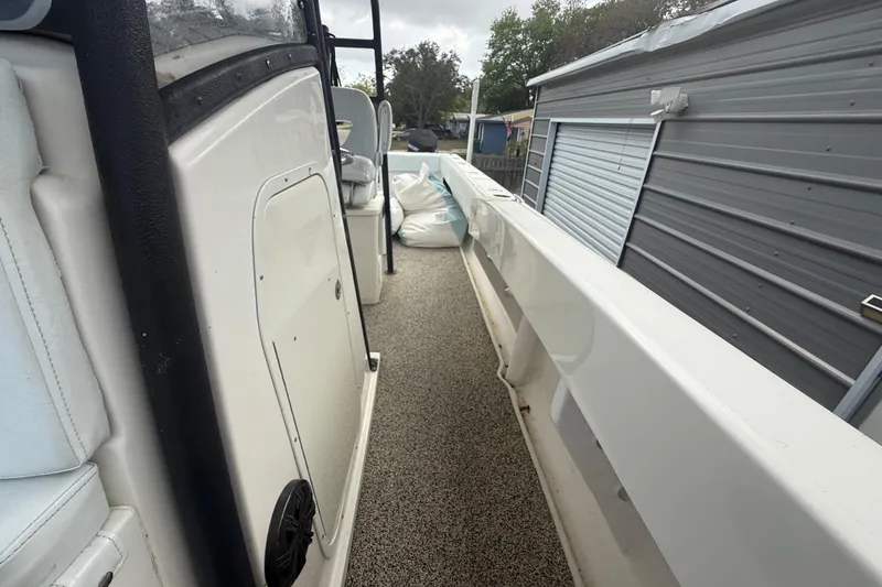 Slide: The Image of 2022 Eastward 30 boat interior with white seating and storage compartments. - 48