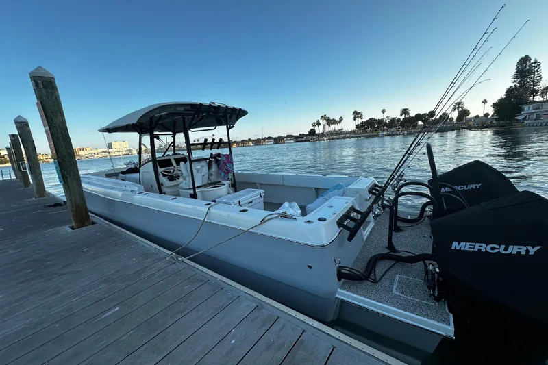 Slide: The Image of 2022 Eastward 30 boat docked, equipped with Mercury engines, fishing rods visible. - 5