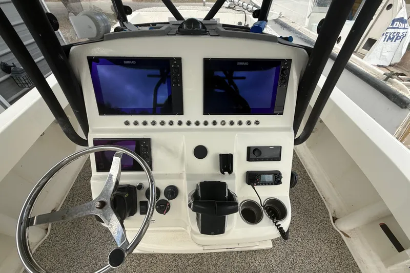 Slide: The Image of Control panel of a 2022 Eastward 30 boat with dual Simrad displays. - 53