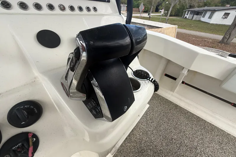 Slide: The Image of Control panel of a 2022 Eastward 30 boat with throttle and switches. - 58