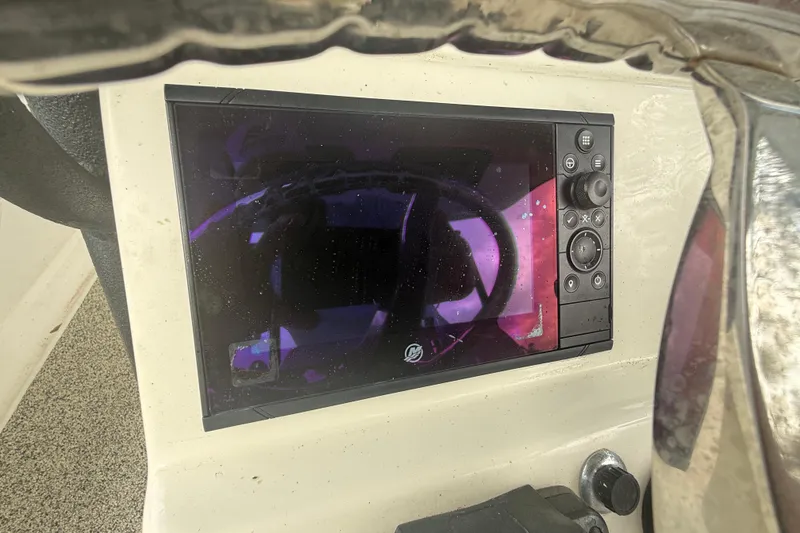 Slide: The Image of Control panel of a 2022 Eastward 30 boat with display screen and buttons. - 59