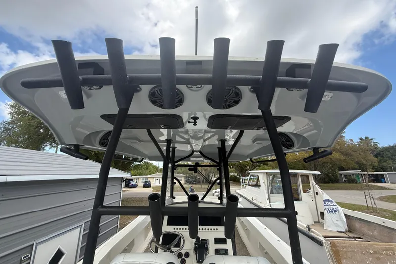 Slide: The Image of 2022 Eastward 30 boat with rod holders and speakers, docked outdoors under cloudy sky. - 71