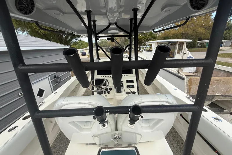 Slide: The Image of Interior view of a 2022 Eastward 30 boat, featuring rod holders and steering console. - 73