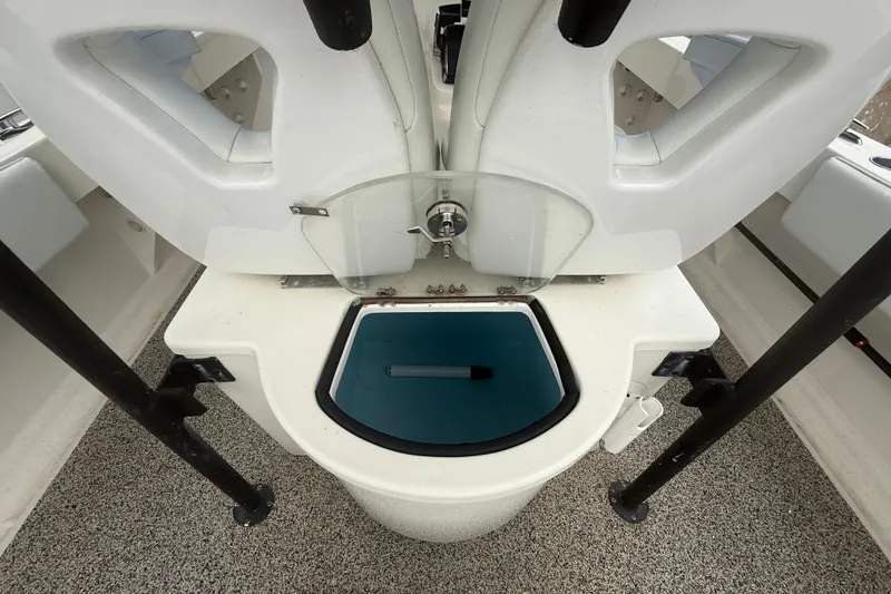 Slide: The Image of Livewell on 2022 Eastward 30 boat, featuring white seating and blue interior. - 74