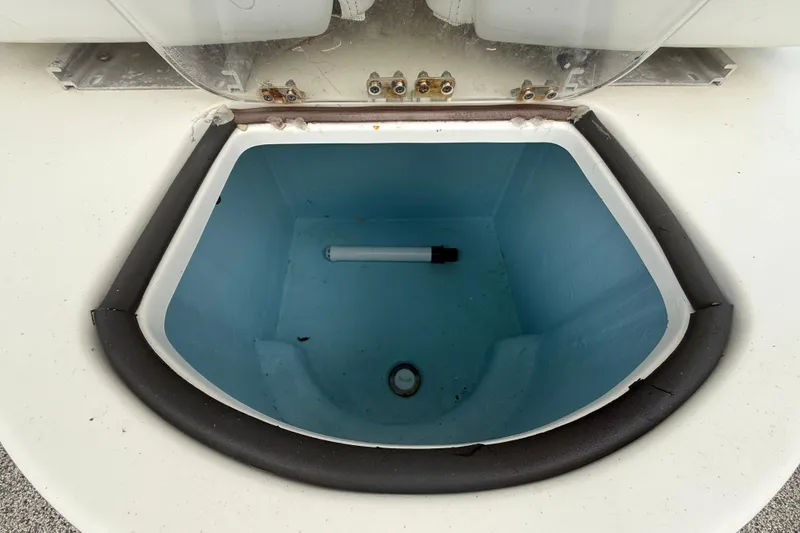 Slide: The Image of Open compartment of Eastward 30 boat, 2022 model, featuring a blue interior and drainage pipe. - 75