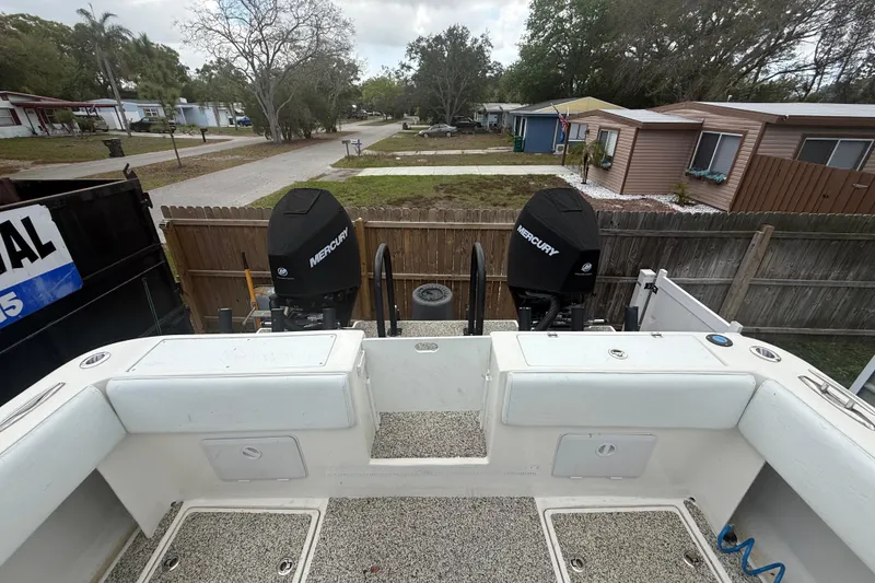 Slide: The Image of Eastward 30 boat with dual Mercury engines, parked in a residential area, 2022 model. - 76