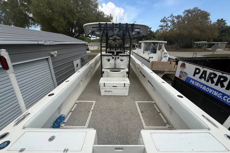 Slide: The Image of 2022 Eastward 30 boat interior with seating and storage, docked near a storage facility. - 81