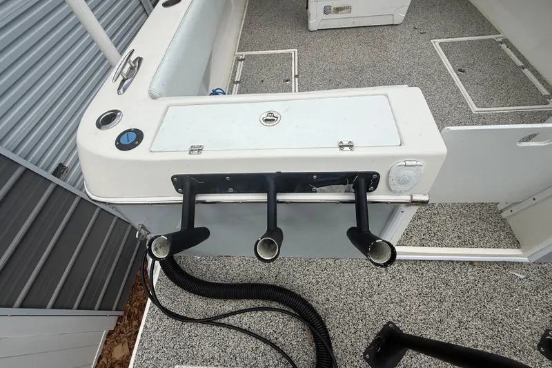 Slide: The Image of 2022 Eastward 30 boat interior with rod holders and storage compartments. - 83