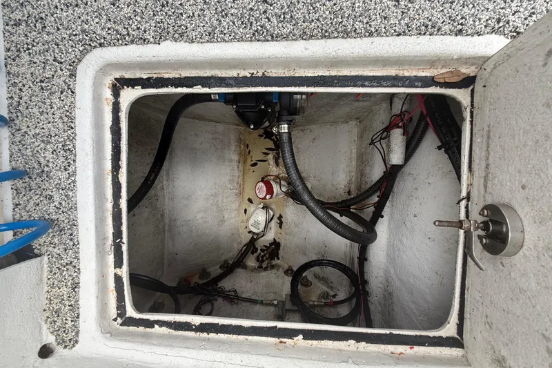 Slide: The Image of Open compartment of 2022 Eastward 30 boat showing internal wiring and components. - 86