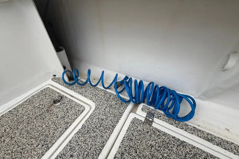 Slide: The Image of Coiled blue hose on Eastward 30 boat deck, 2022 model. - 87