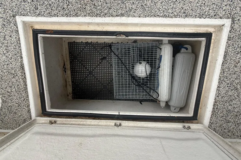 Slide: The Image of Storage compartment on Eastward 30 boat, containing fenders and a ball, 2022 model. - 89