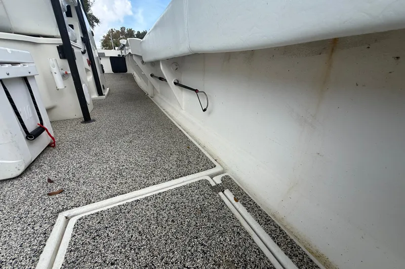 Slide: The Image of Interior view of a 2022 Eastward 30 boat, featuring textured flooring and storage compartments. - 90