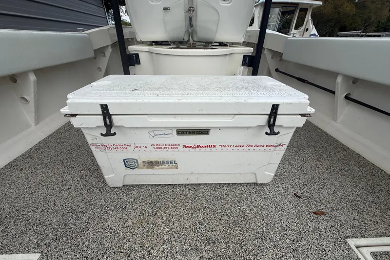 Slide: The Image of White cooler on Eastward 30 boat deck, 2022 model, with safety and service stickers. - 92