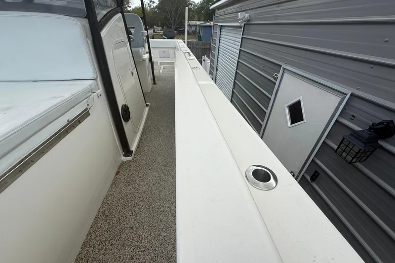 Slide: The Image of 2022 Eastward 30 boat deck beside a metal building with a small door. - 96