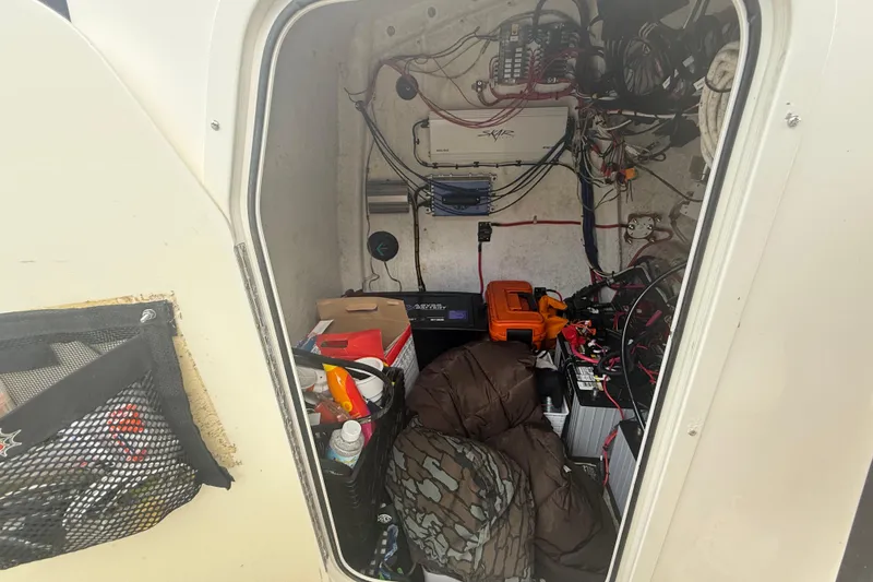Slide: The Image of Interior of 2022 Eastward 30 boat showing storage and electrical components. - 97