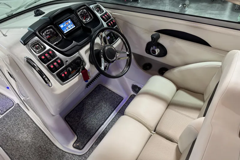 Slide: The Image of 2014 Chaparral 287 SSX boat cockpit with modern dashboard and steering wheel. - 11