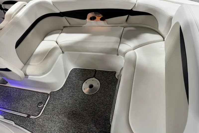 Slide: The Image of 2014 Chaparral 287 SSX boat interior with white seating and carpeted floor. - 7