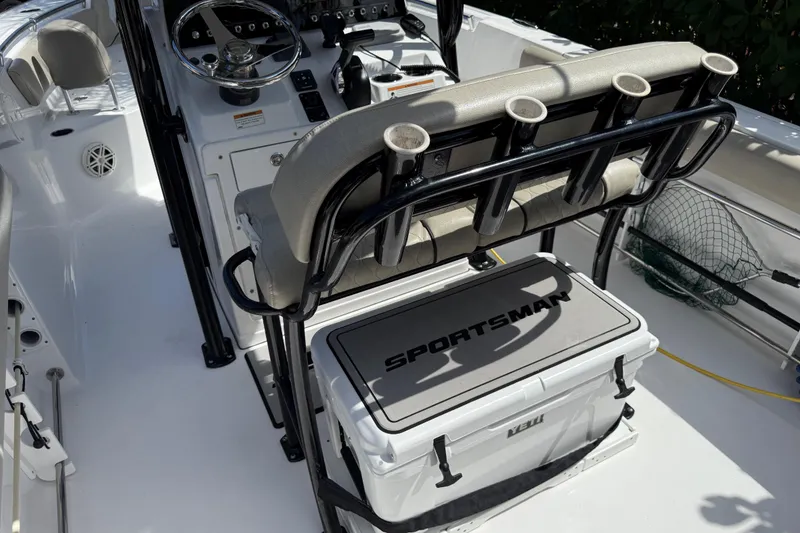 Slide: The Image of 2021 P Open 232 Center Console boat interior with fishing rod holders and cooler. - 11