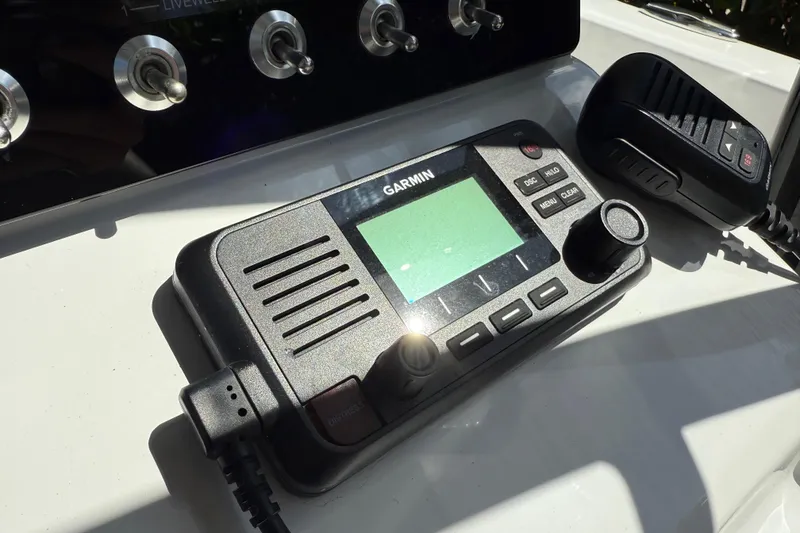 Slide: The Image of Garmin marine radio on 2021 P Open 232 Center Console boat dashboard. - 13