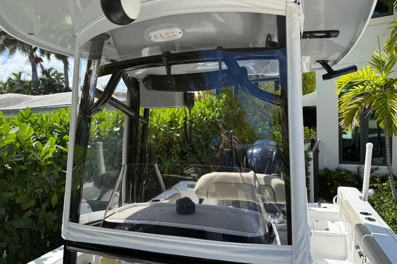 Slide: The Image of 2021 P Open 232 Center Console boat with clear windshield and lush greenery background. - 15