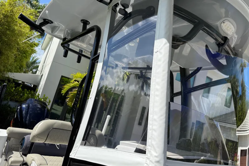 Slide: The Image of 2021 P Open 232 Center Console boat with seating and canopy, outdoors. - 17