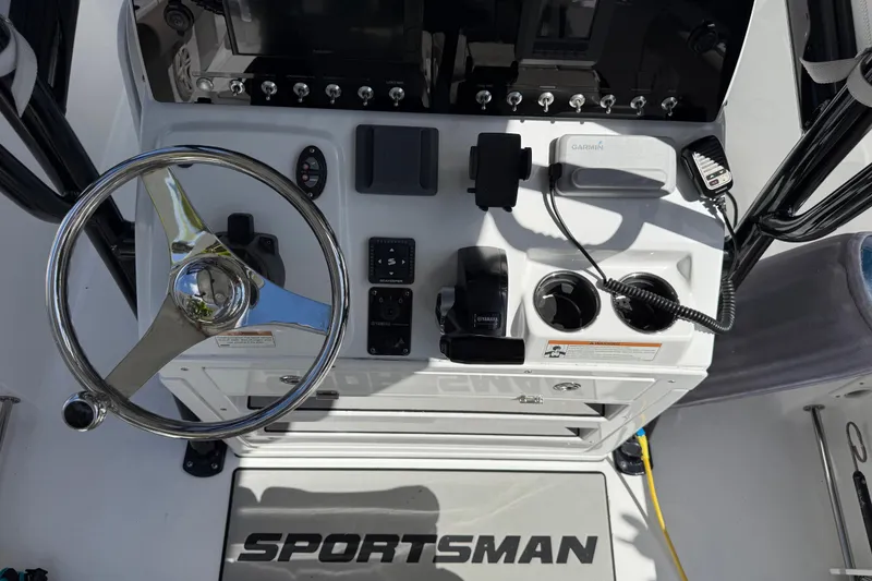 Slide: The Image of 2021 P Open 232 Center Console boat dashboard with steering wheel and controls. - 20