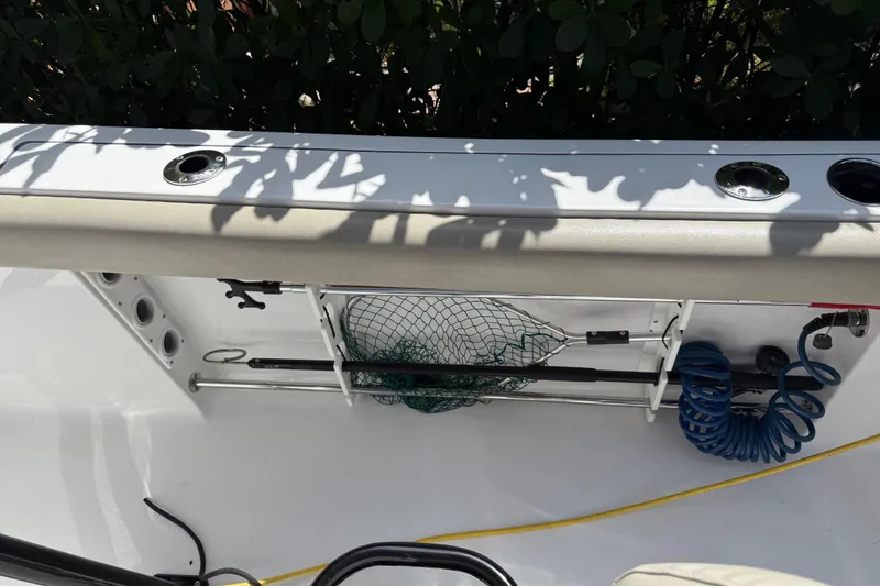 Slide: The Image of 2021 P Open 232 Center Console boat interior with fishing gear and coiled hose. - 22