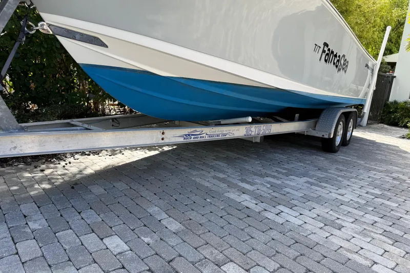 Slide: The Image of 2021 P Open 232 Center Console boat on trailer, parked on cobblestone driveway. - 27