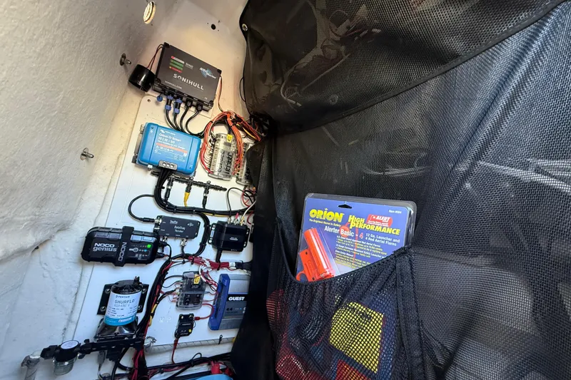 Slide: The Image of 2021 P Open 232 Center Console electrical panel with wiring and safety equipment. - 31