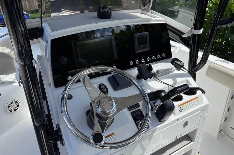 Slide: The Image of 2021 P Open 232 Center Console boat dashboard with steering wheel and controls. - 8
