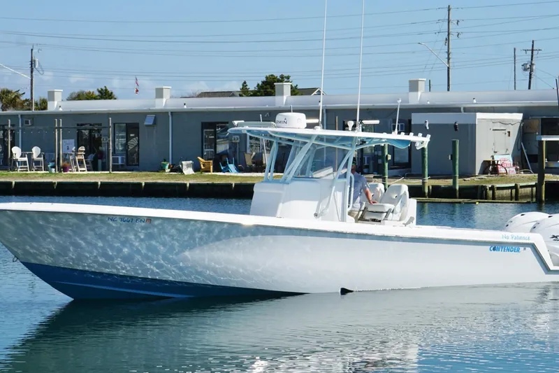 The Image of 2020 Contender 35 ST boat docked in a marina, clear blue water, sunny day. - 0