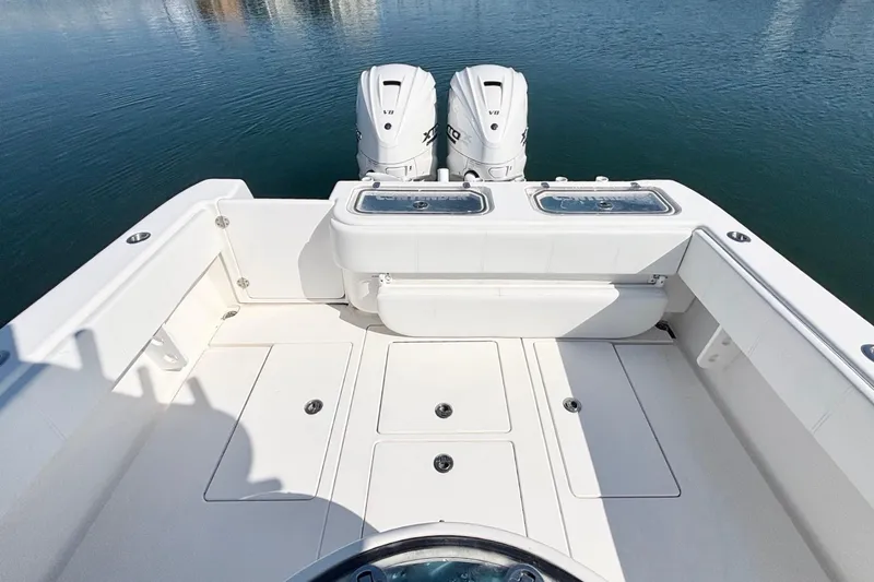 Slide: The Image of 2020 Contender 35 ST boat deck with twin engines on calm water. - 12