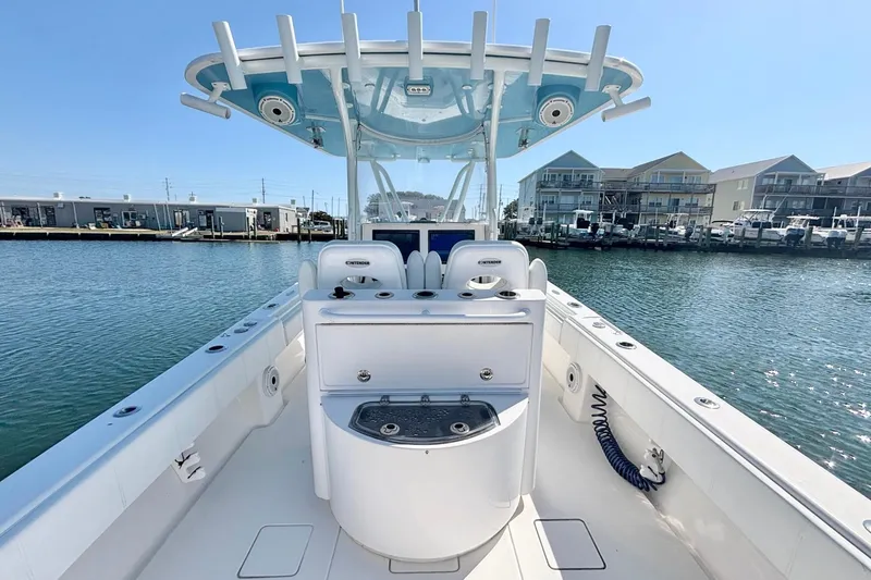 Slide: The Image of 2020 Contender 35 ST boat interior with helm station, docked near waterfront buildings. - 15