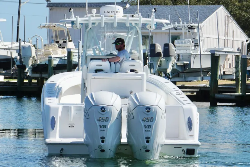 Slide: The Image of 2020 Contender 35 ST boat with dual Yamaha 450 V8 engines in a marina setting. - 2