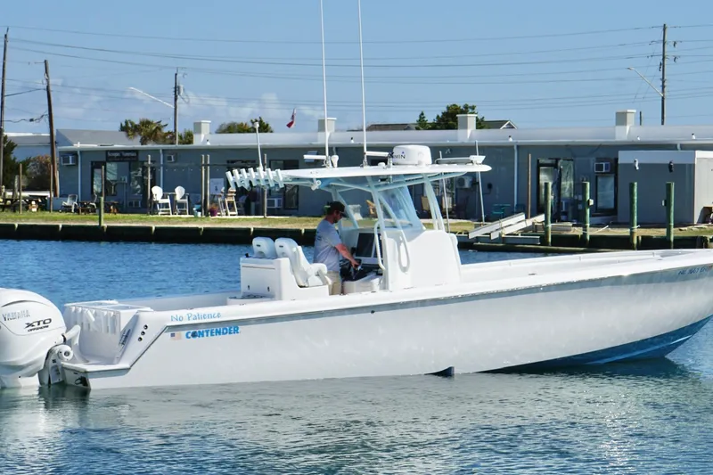 Slide: The Image of 2020 Contender 35 ST boat on water near dockside buildings. - 3