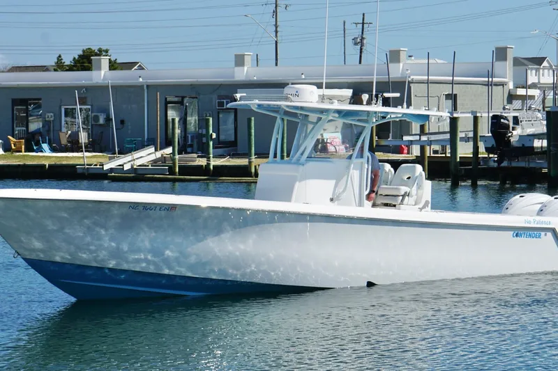 Slide: The Image of 2020 Contender 35 ST boat docked in marina, clear blue water, sunny day. - 5